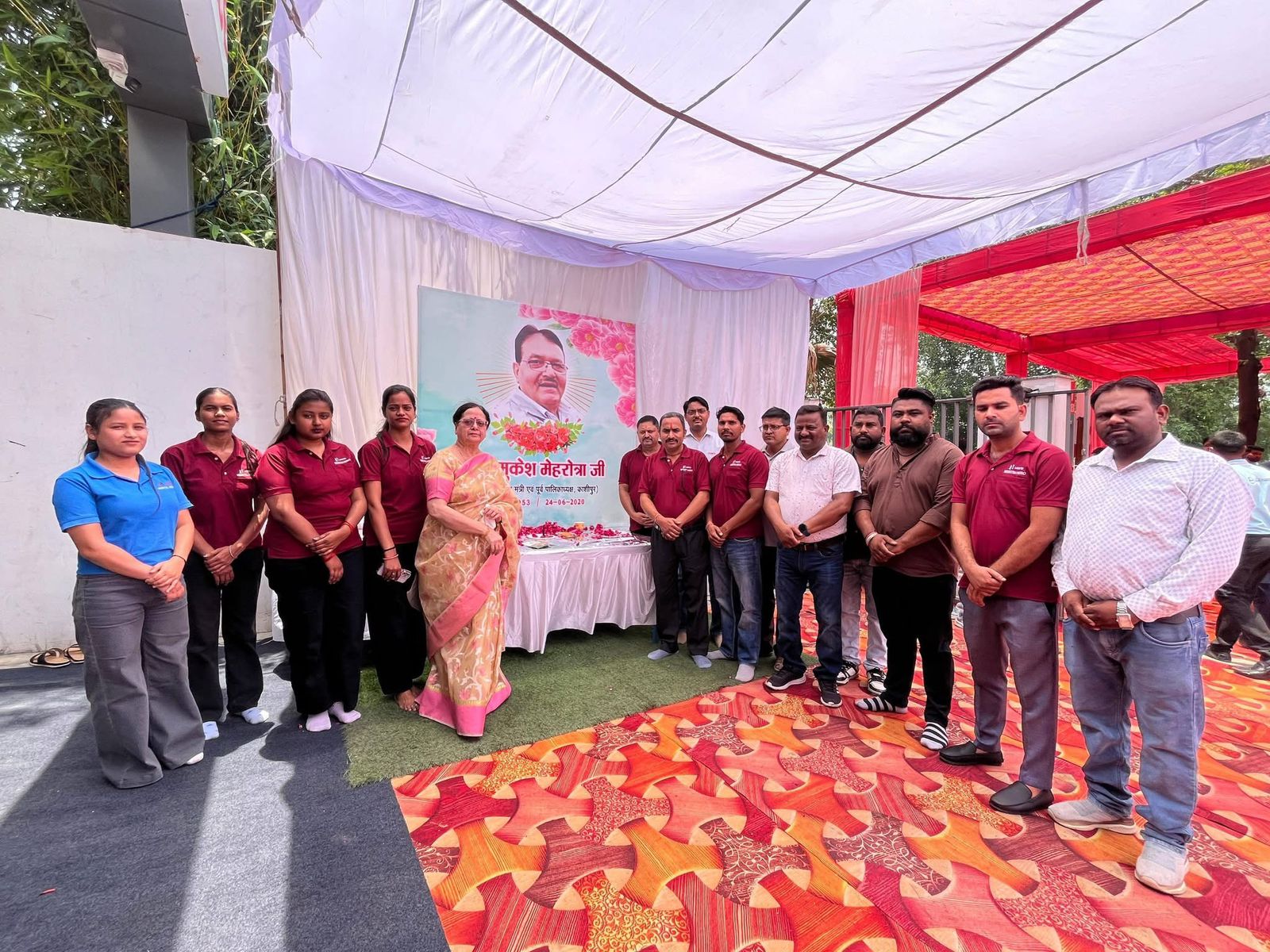 Beena Mehrotra with the Su-vastika family beside the portrait of Late Shri Mukesh Mehrotra